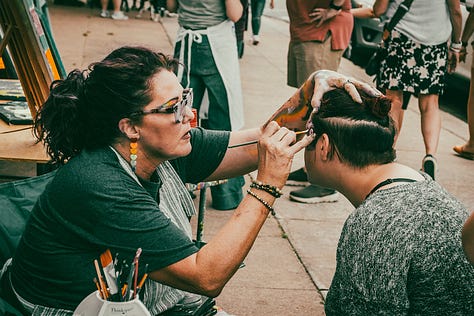 Face painting, the Downtown Farmer's Market, and artists selling their creations