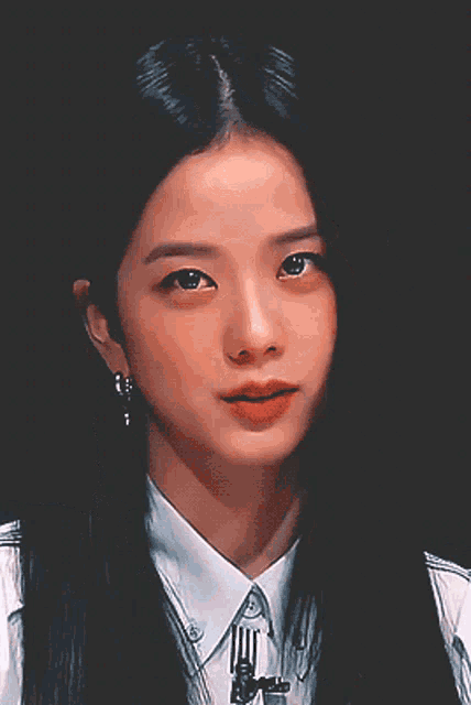 a close up of a woman 's face with a microphone behind her