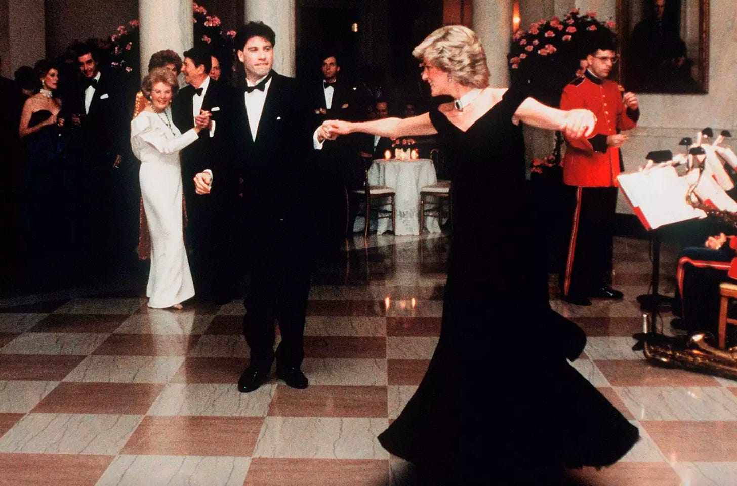 A young John Travolta spins Princess Diana around the dance floor at the White House during a State Dinner in the 1980s hosted by Ronald and Nancy Reagan in Washington, DC. 