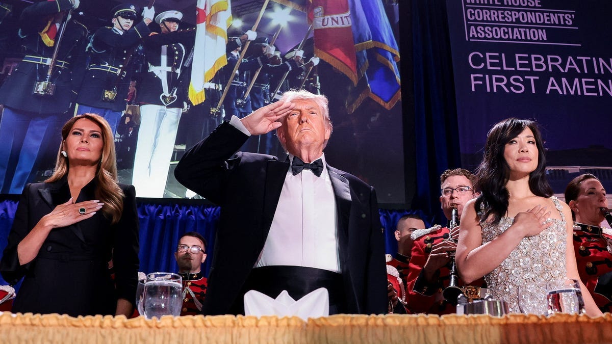 President Donald Trump, with first lady Melania Trump and CBS News senior White House correspondent Weijia Jiang, salutes during the annual White House Correspondents' Association dinner in Washington, D.C., U.S., April 25, 2026. President Donald Trump, with first lady Melania Trump and CBS News senior White House correspondent Weijia Jiang, salutes during the annual White House Correspondents' Association dinner in Washington, D.C., U.S., April 25, 2026.