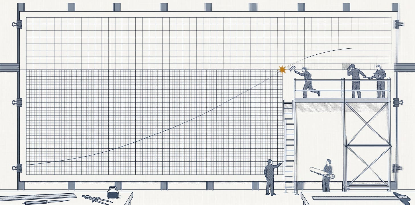 Wide elevation view of a vast wall-mounted plotting chart, seen from directly in front. The chart fills most of the frame and is divided into two regions with visibly different grid densities: a large rectangle of finely-ruled slate-blue grid occupies the lower-left, while a coarser grid wraps around it in an L-shape — running across the upper portion of the chart and continuing down the right side. A single fine slate-blue trendline rises from the lower-left of the fine-grid region in a gently accelerating curve, crosses the boundary at the inner corner where the coarse-grid L meets the fine-grid rectangle, continues briefly onto the coarse-grid region, and terminates cleanly within the chart paper. A small amber-gold starburst marks the precise point of the crossing. On the right side of the frame, a tall scaffolding platform stands in front of the wall: three small human figures in slate blue work on the scaffolding doing finishing tasks — one runs a smoothing roller along the seam, another inspects a section of the new ruling, a third passes a tool. A simple ladder rises from ground level to the scaffolding. At ground level, two more figures stand back from the chart: one gestures toward the seam with hand raised, the other holds a rolled bundle of paper prepared for a future extension. The chart is held to the wall by dark grey brass clips at regular intervals along its top and side edges; vertical support beams behind the chart and a horizontal track above suggest a working installation. Along the lower edge of the frame, a parallel rule, a pair of dividers, an open ink pot, and a T-square rest on a low shelf. All primary linework is in fine slate blue (#334155) on an off-white linen-textured background; the small amber-gold starburst is the only non-slate color in the image.
