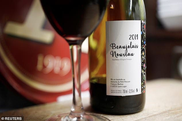 Global phenomenon: Bottle of  Beaujolais Nouveau wine is pictured in a bistrot in Paris, France, November 20. The third Thursday of November — became known as Beaujolais Nouveau Day while earning Duboeuf the nickname the ‘Pope of Beaujolais’ and making him fabulously wealthy