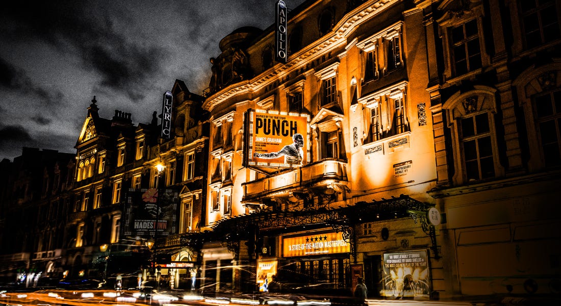 A theatre with orange glowing lights and a sign for 'Punch' A theatre with orange glowing lights and a sign for 'Punch'