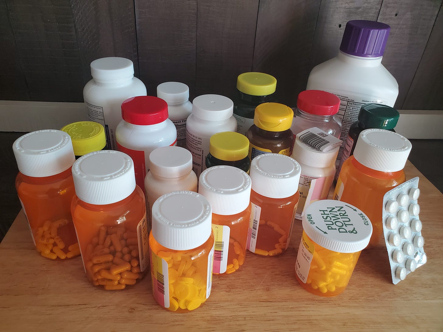Photo of numerous bottles and sleeves of medications gathered together