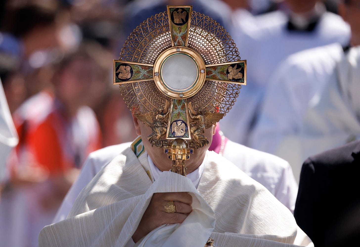 Pope Leo XIV holds the monstrance during the Corpus Christi procession in Madrid