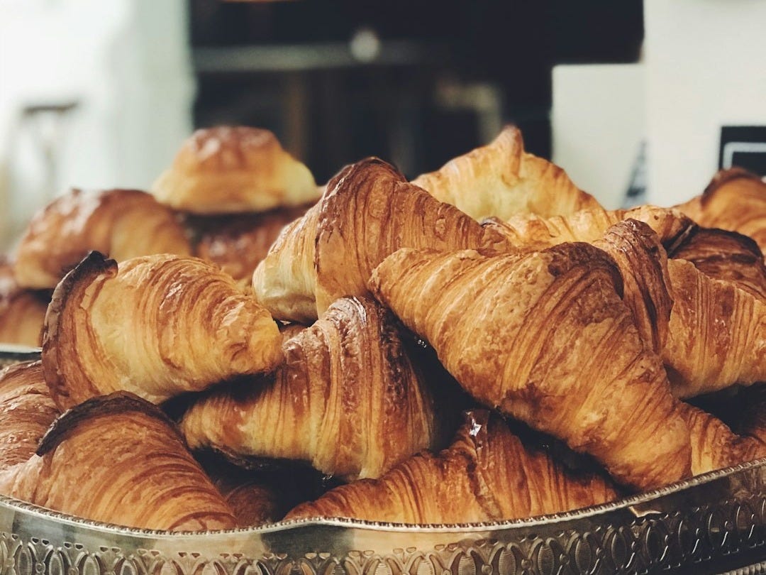 croissant on top of stainless steel tray