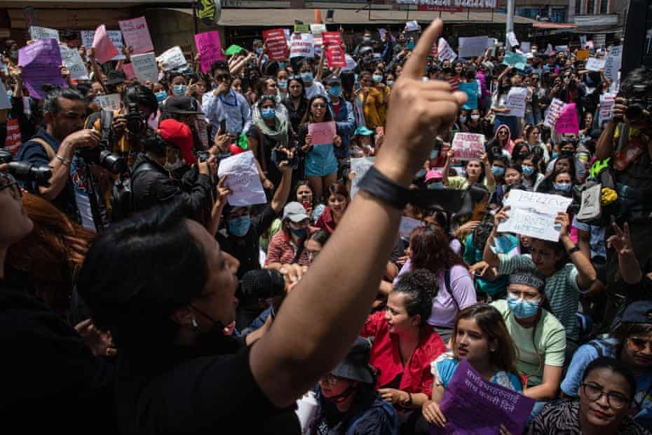 A woman speaks to a crowd of protesters