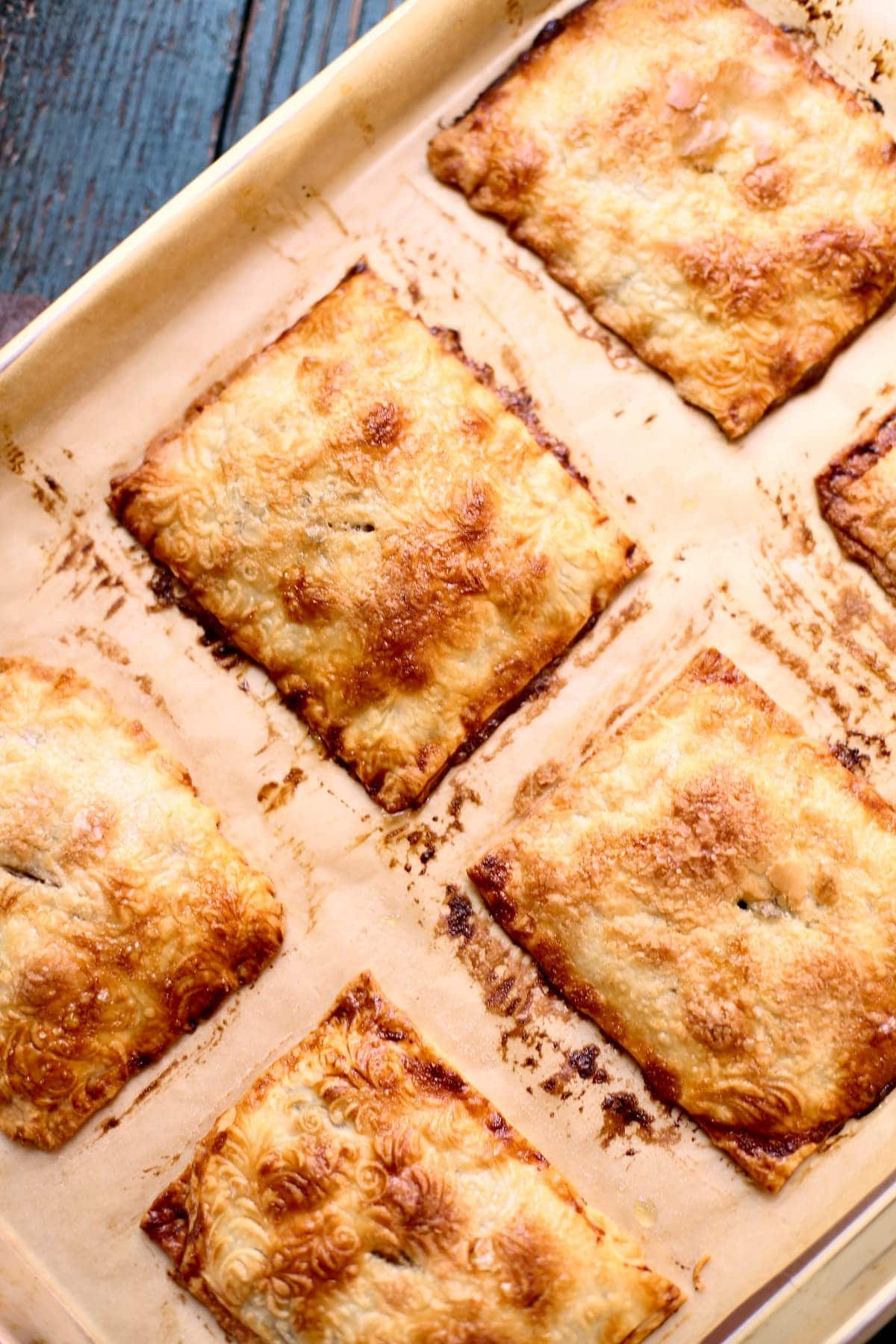 a baking sheet with baked hand pies, fresh out of the oven.