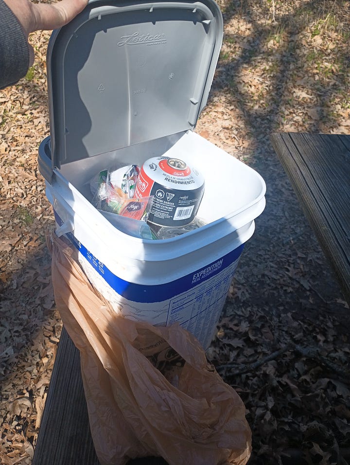 left picture is a 5 gallon water container and Jet Boil; right picture is the plastic food box with the lid flipped up