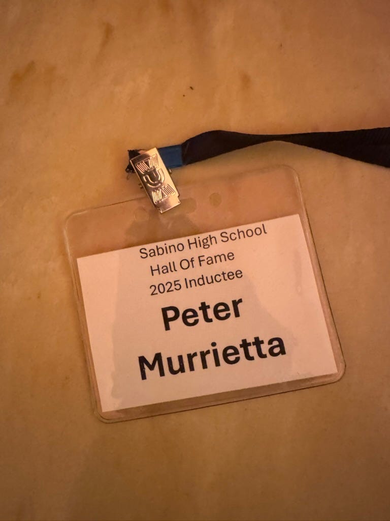 A name tag with a black ribbon

AI-generated content may be incorrect.