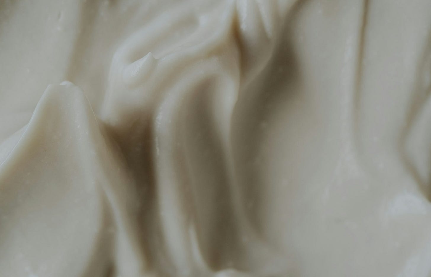 A close up of a white frosted cake