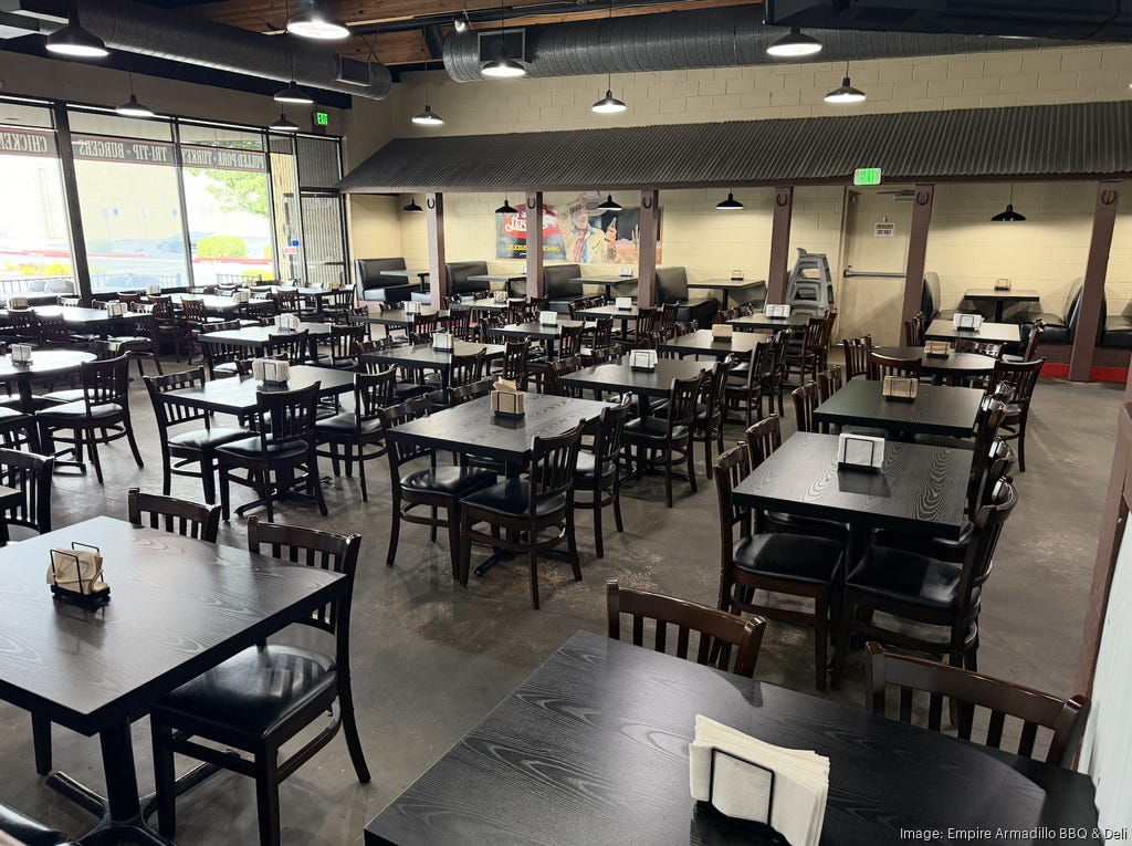 Interior of Empire Armadillo. There are many restaurant style tables and chairs.