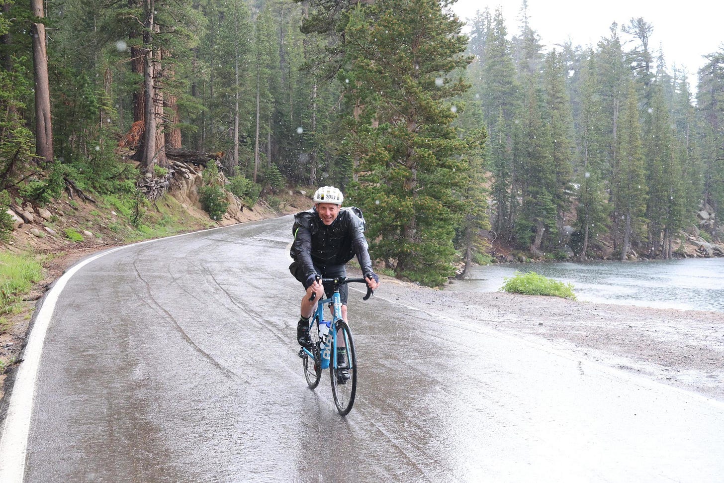 David Gottfried wearing a garbage bag riding his bike in the rain