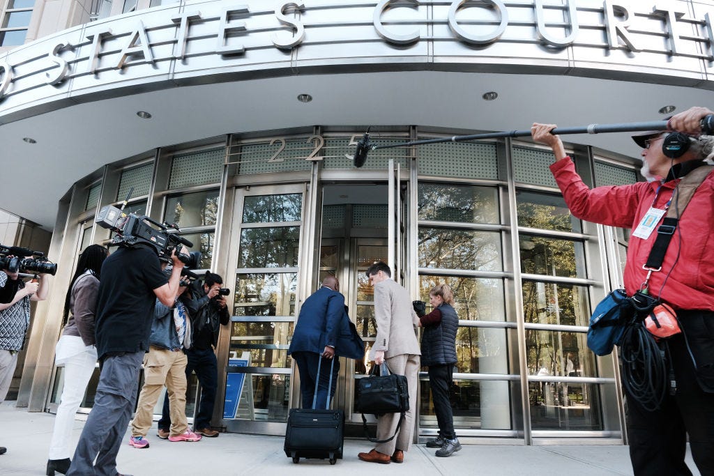 Lawyers and journalists outside of Brooklyn federal court.
