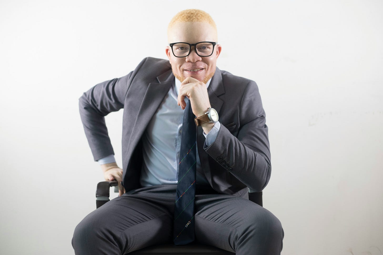 Professional disabled entrepreneur with albinism in wheelchair wearing business suit, representing AI-powered accessibility in modern entrepreneurship Professional disabled entrepreneur with albinism in wheelchair wearing business suit, representing AI-powered accessibility in modern entrepreneurship