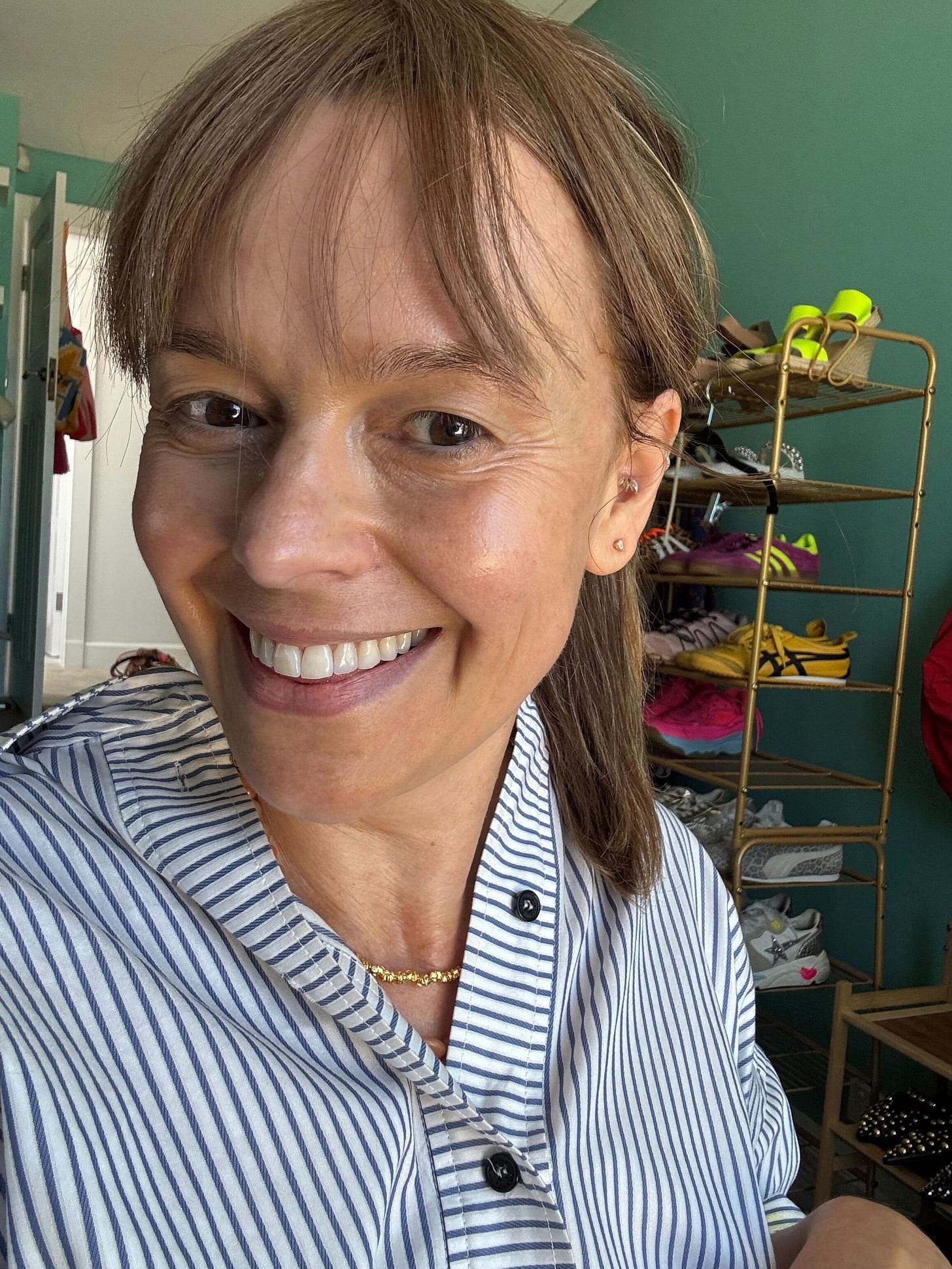 Mia smiling wearing a fake fringe.