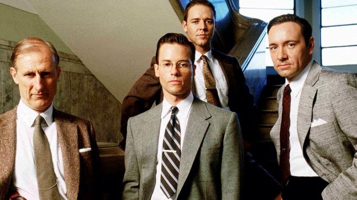 This may contain: three men in suits and ties standing next to each other with their hands on their hipss