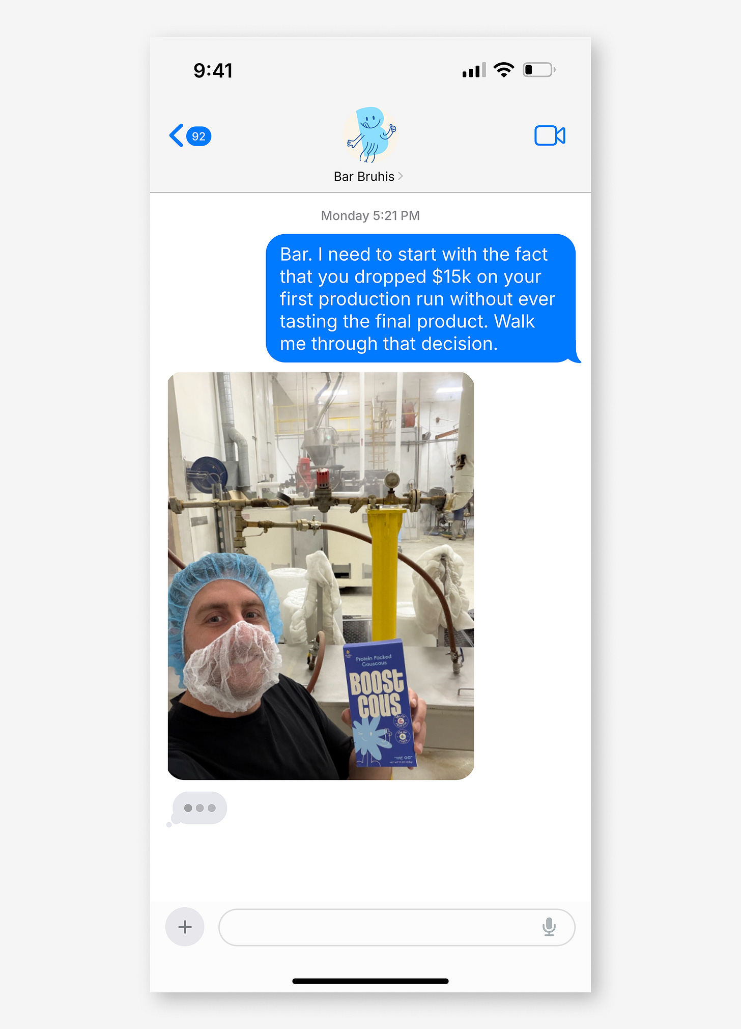 iMessage conversation with Bar Bruhis. Blue bubble reads: "Bar. I need to start with the fact that you dropped $15k on your first production run without ever tasting the final product. Walk me through that decision." Below, a photo of Bar in a hairnet and mask at a factory, holding a box of Boostcous Protein Packed Couscous. A typing indicator shows below iMessage conversation with Bar Bruhis. Blue bubble reads: "Bar. I need to start with the fact that you dropped $15k on your first production run without ever tasting the final product. Walk me through that decision." Below, a photo of Bar in a hairnet and mask at a factory, holding a box of Boostcous Protein Packed Couscous. A typing indicator shows below