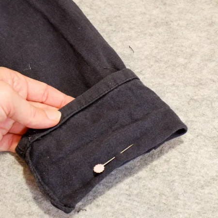 measuring how much pants should be shortened, flower pin to mark the desired length