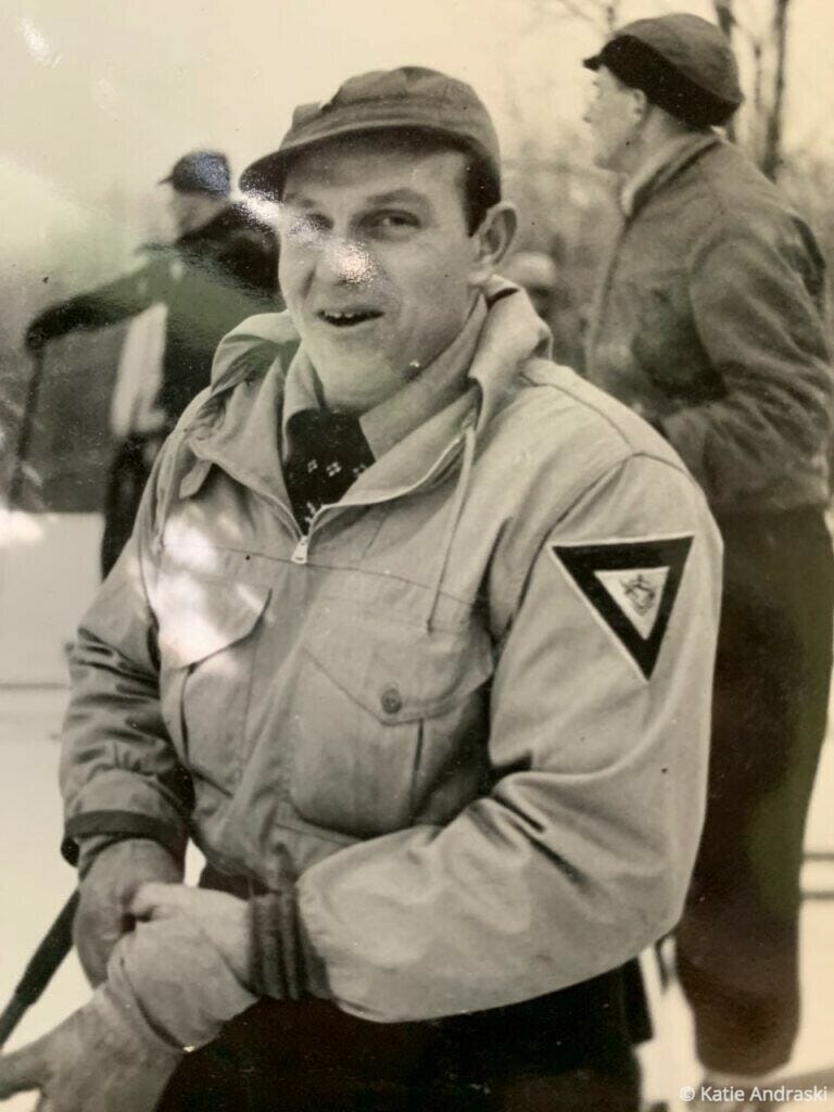 Black-and-white photo of a soldier in uniform with a triangular patch.