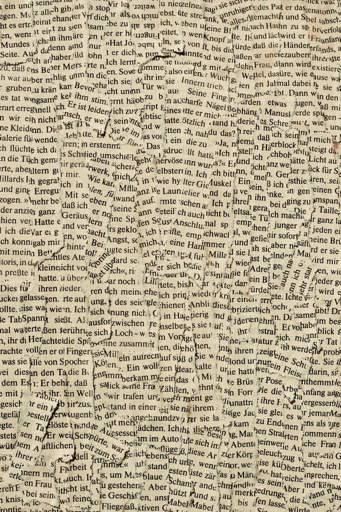 A collage of words torn from a bok and repasted onto a board.
