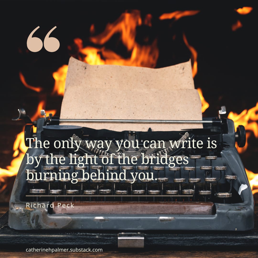a blue typewriter with a fire very close behind it.