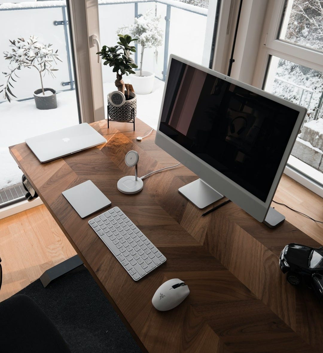 a desk with a computer, keyboard and mouse