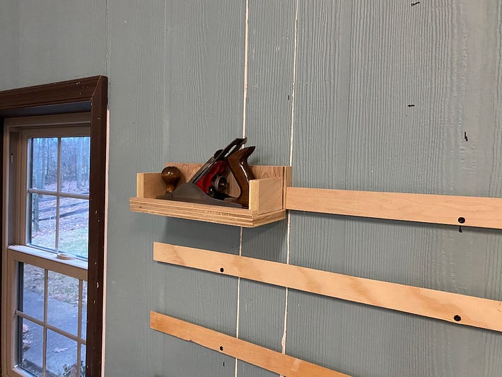 Wall-mounted French cleats to hold my planes and other things.