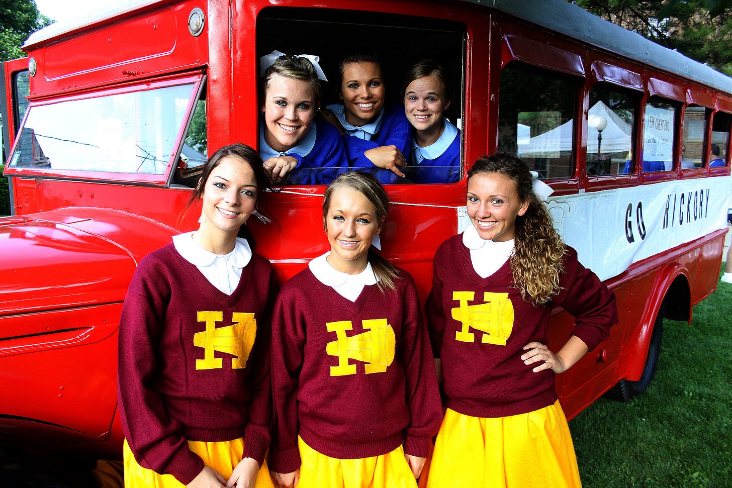 Each June, Hoosier Basketball magazine and the Hoosier Gym team up for the Hoosiers Reunion All-Star Classic Doubleheader, which features Indiana’s top male and female preps talent, also known as the Indiana All-Stars. Since the Hoosier Gym is in Henry County, organizers often select premium area players to join in the throwback games. Boys and girls teams square off in “Hickory” and “Terhune” uniforms. Likewise, cheerleaders from Knightstown High School don period cheerleading costumes, leading the gym’s cheer blocks in nostalgic cheers from back in the day. In this 2010 photo, cheerleaders pose with the original fan bus used in the film.