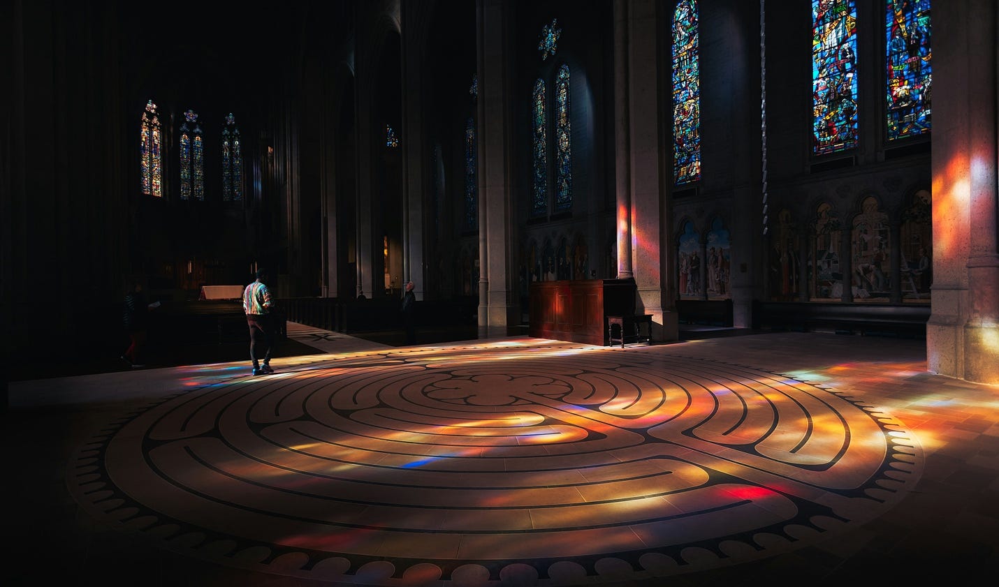 A person walking in a large room with stained glass windows

AI-generated content may be incorrect.
