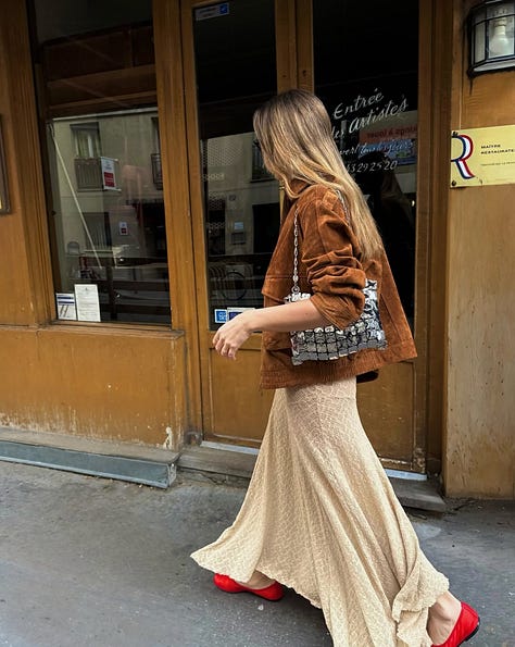 Collage of fall street-style trends: cherry-red jelly flats with white dress; white no-logo sneakers on NYC pavement; cropped boxy jacket; loafers with straight-leg jeans; motor buckle boots under flowy dress; classic beige trench coat.