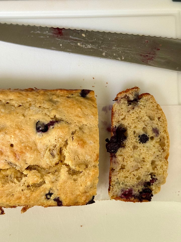 Left: White bowl with a hand mixing yellow batter. Right: A loaf of blueberry banana bread next to a knife.