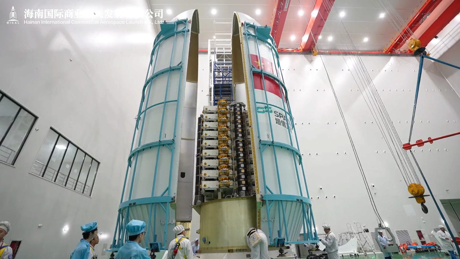 A batch of eighteen Qianfan satellites, split into two groups of nine, being encapsulated inside a Long March 8’s fairing at the Wenchang Commercial Space Launch Site. A batch of eighteen Qianfan satellites, split into two groups of nine, being encapsulated inside a Long March 8’s fairing at the Wenchang Commercial Space Launch Site.