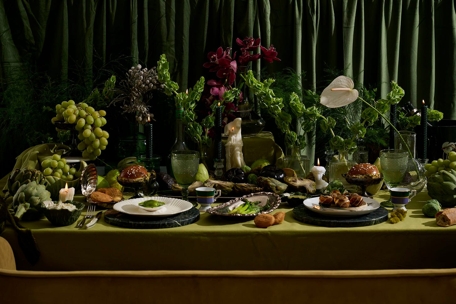 Full spring dinner party table with green grapes, artichokes, asparagus, scallops, savory madeleines, florals, and candlelight — lush VERTE tablescape by Paris Dining Club
