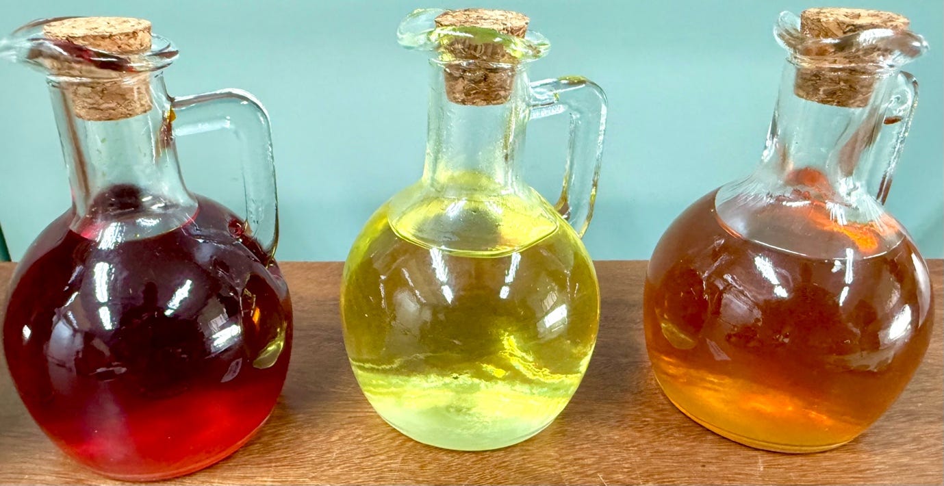 A group of glass jugs with liquid in them

AI-generated content may be incorrect.