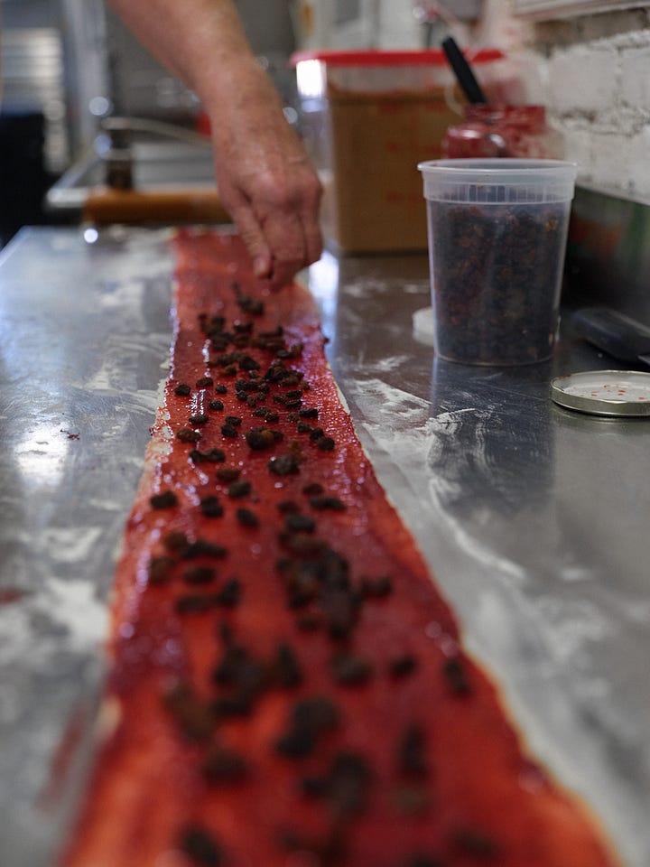 Sprinkling the raising, rolling the the filled dough into a spiraled log