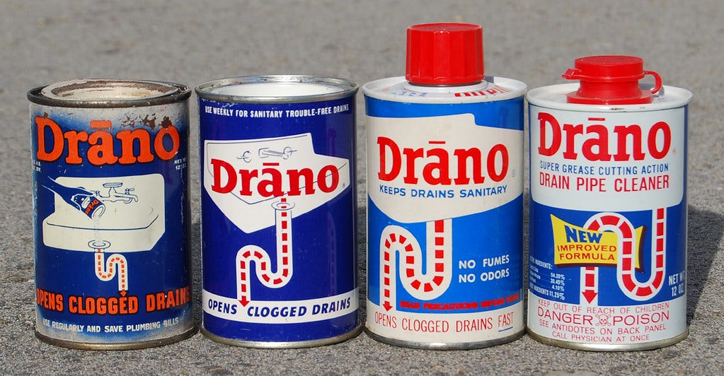 Cans of vintage Drano for opening clogged drains from different periods of the 20th century show the evolution of the brand.