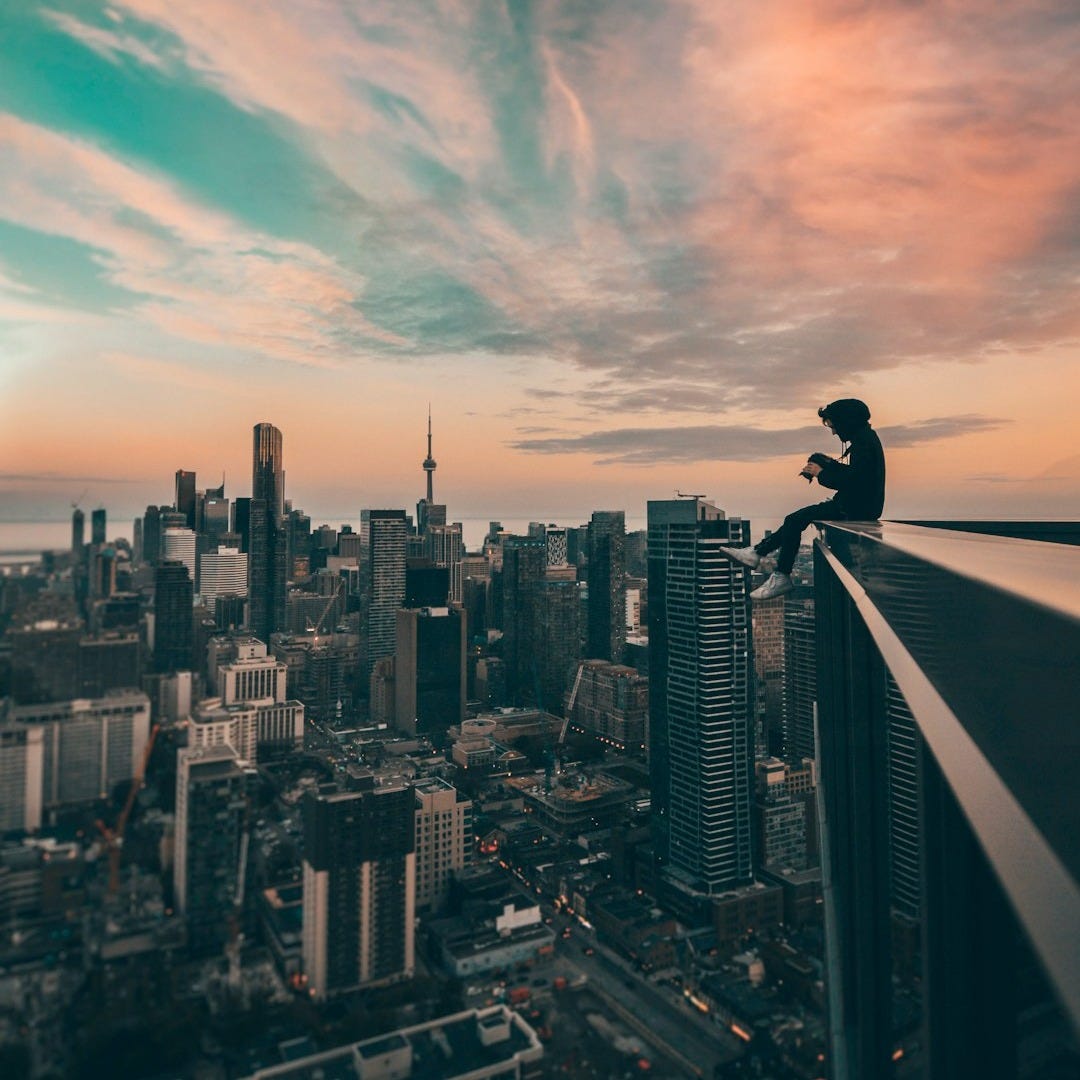 person sitting on top of the building person sitting on top of the building