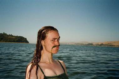 sarah in the water with a seaweed mustache