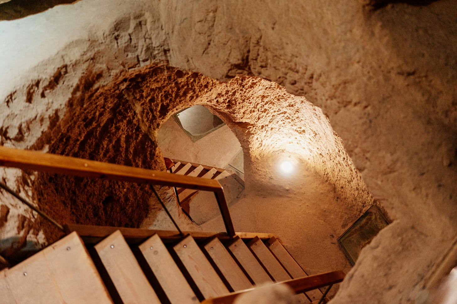 staircases leading down into a stone cavern. staircases leading down into a stone cavern.