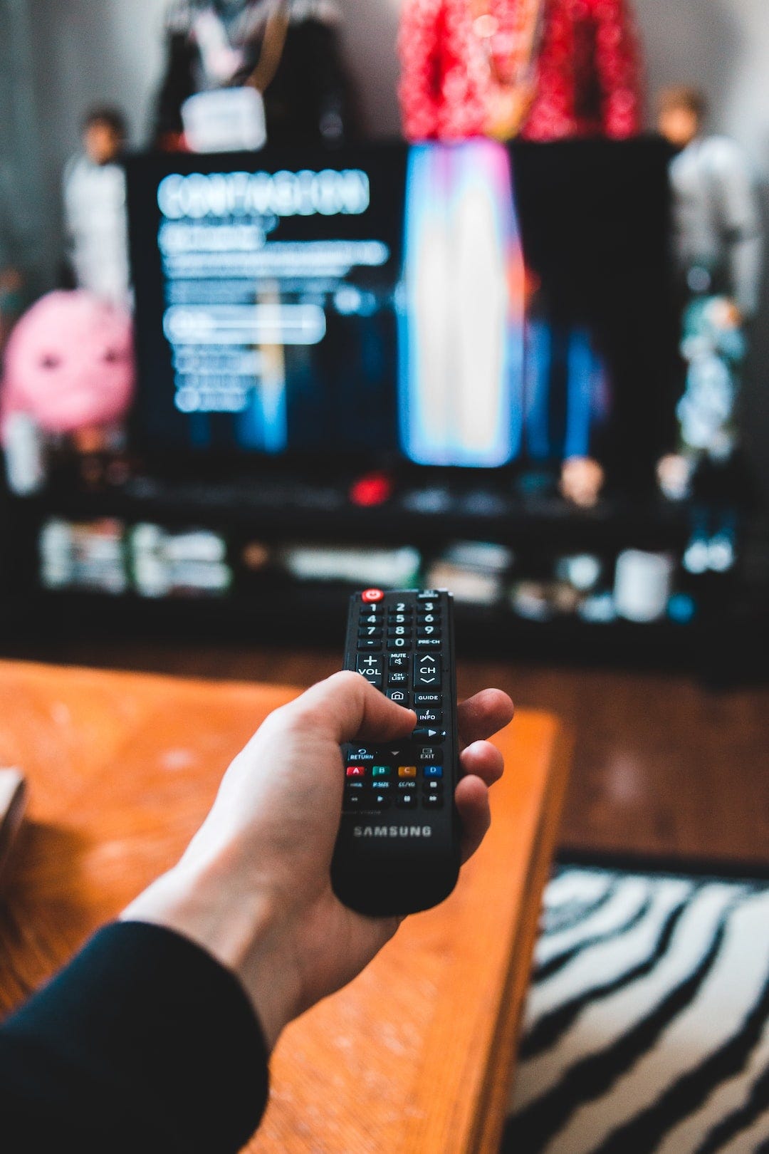 person holding black remote control person holding black remote control