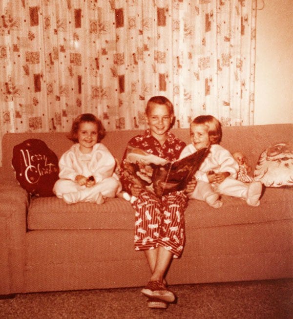 Eye-level view of a traditional Christmas wreath with candles and holly on a wooden table