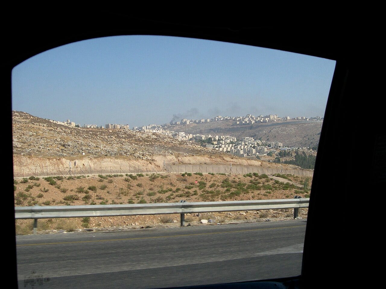 two israeli settlements on the hills of the west bank (as viewed from our passing taxi). there was a parallel system of roads that makes it easy (and safer) for settlers to move between settlements and israel proper. we were on the palestinian road w