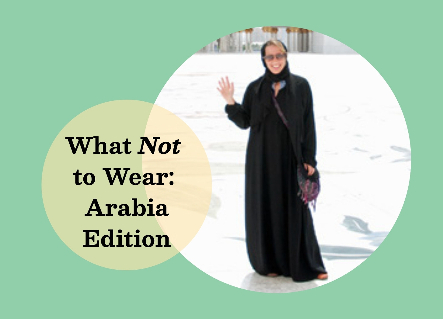 White woman wearing sunglasses and a black abaya robe standing in front of a large white marble mosque.