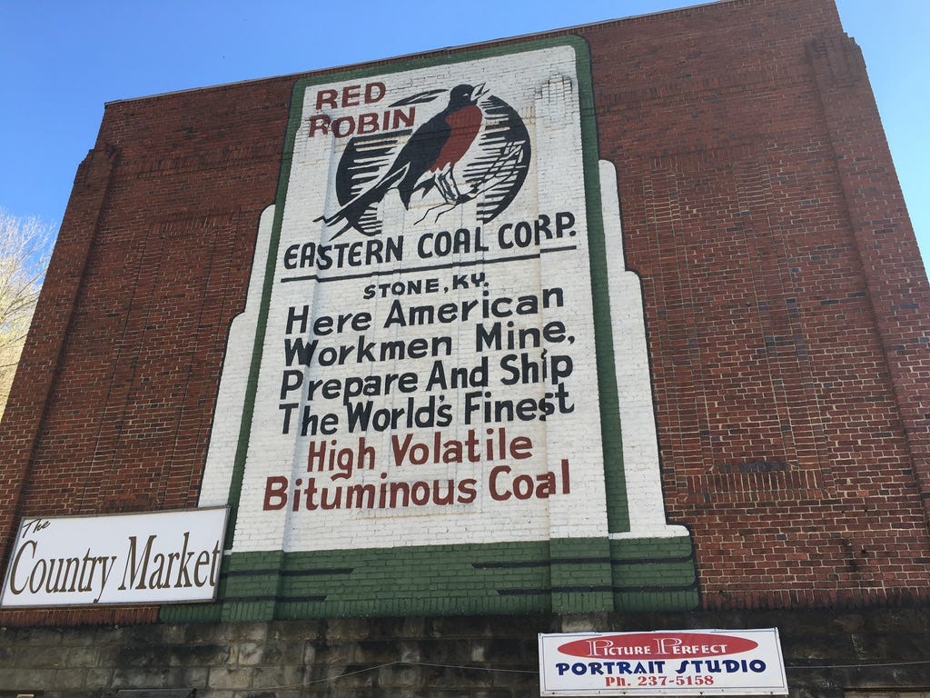brick building with a Red Robin Coal mural