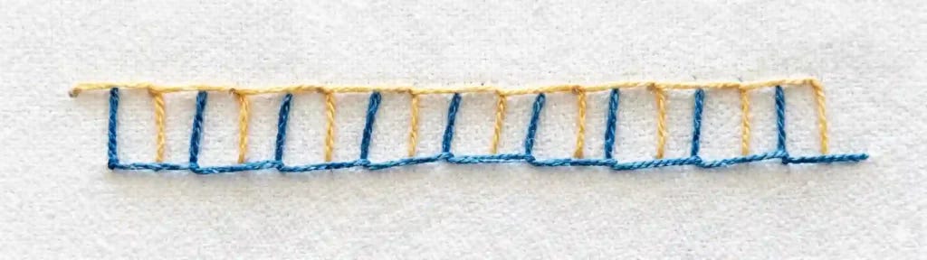 double blanket stitch row in blue and yellow