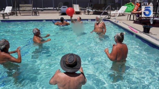 A group of older adults play with a red ball in a swimming pool at Olive Dell Ranch in Colton, California. A group of older adults play with a red ball in a swimming pool at Olive Dell Ranch in Colton, California.