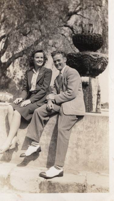 A person and person sitting on a ledge

AI-generated content may be incorrect.