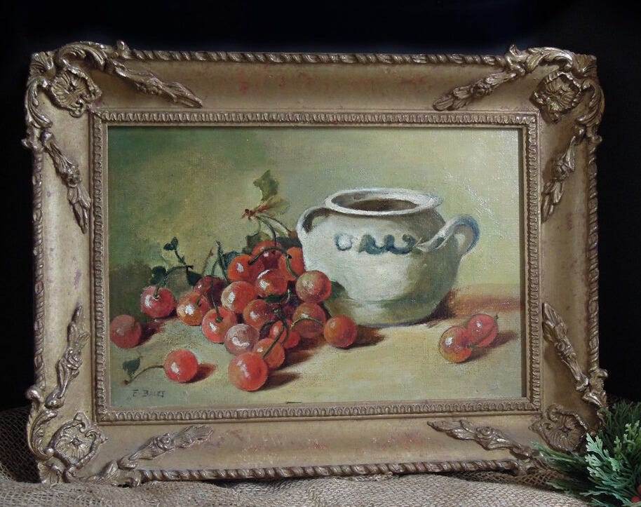 May include: A framed oil painting of a still life with a white ceramic pitcher and a cluster of red cherries on a green background. May include: A framed oil painting of a still life with a white ceramic pitcher and a cluster of red cherries on a green background.
