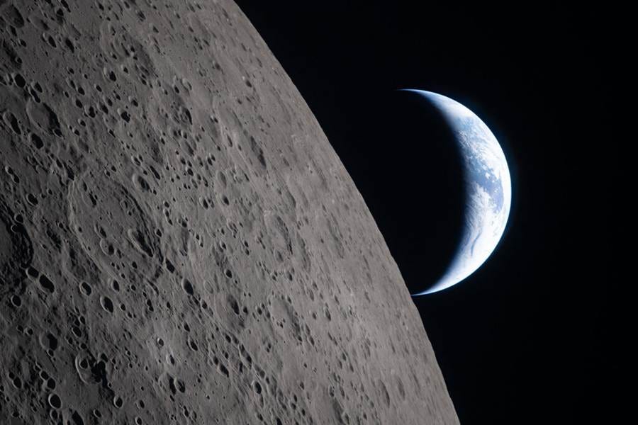 A partial view from space of the moon and crescent Earth. A partial view from space of the moon and crescent Earth.